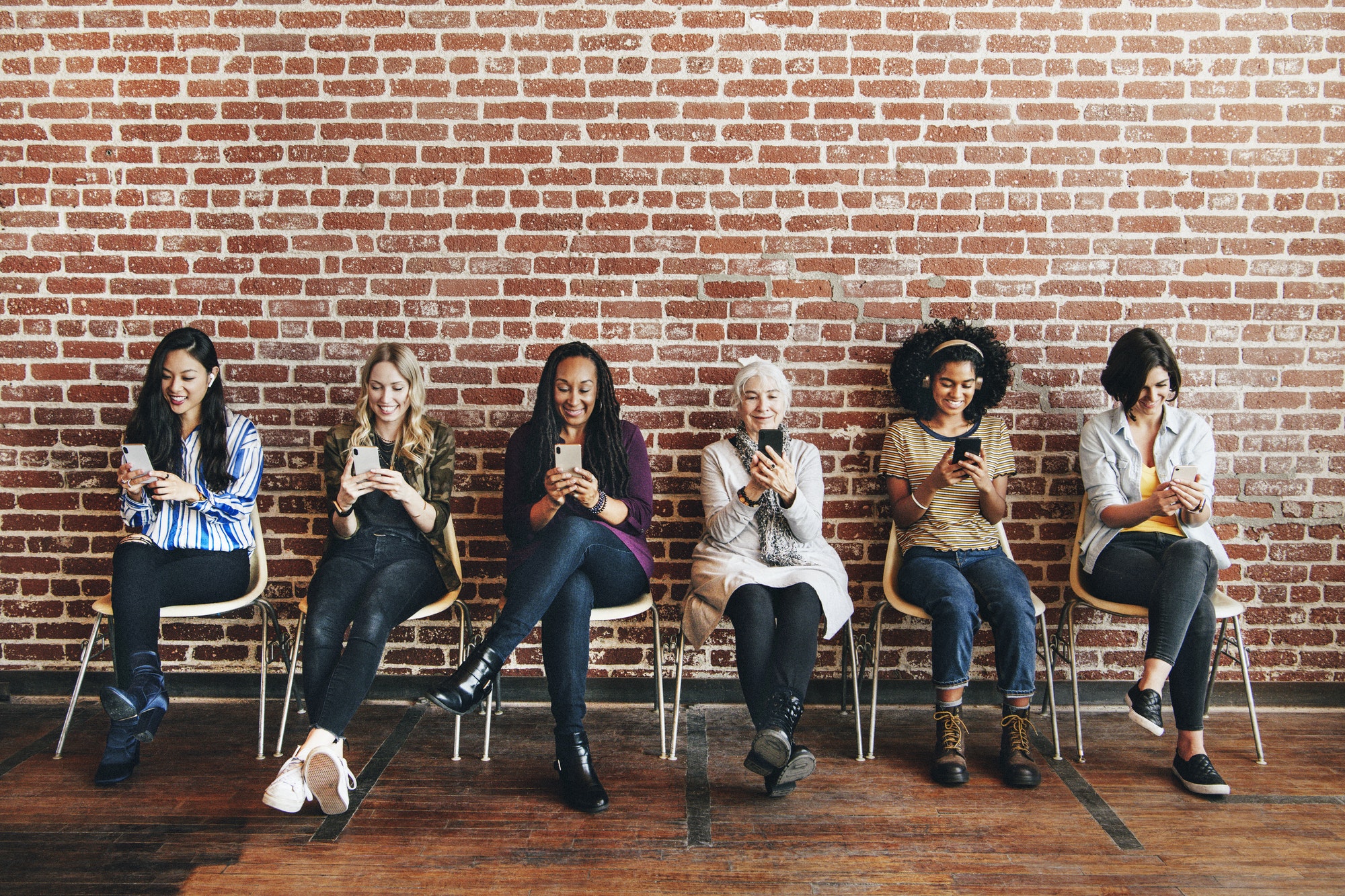 Diverse women concentrating on their phones